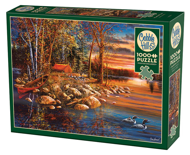 Casse-tête Cobble Hill 1000 pièces – Réveil – Illustration de Jim Hansel représentant un lever de soleil automnal au bord d’un lac, avec huards, forêt dorée et reflets paisibles sur l’eau.