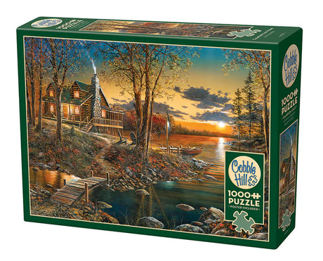 Casse-tête Cobble Hill 1000 pièces – Le confort de la maison – Illustration de Jim Hansel montrant une cabane en rondins au bord d’un lac, entourée de feuillage d’automne et éclairée par un coucher de soleil paisible.